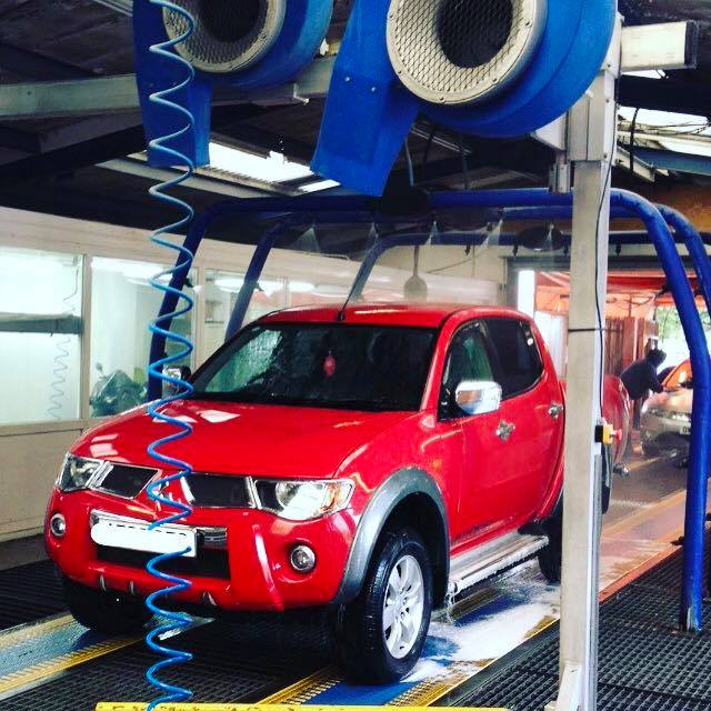 Car going through the Bubbles Car Spa wash tunnel, Redhill, UK